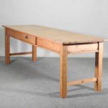 A large antique pine kitchen table, containing a single drawer, on square legs 232w x 77d x 78h cm