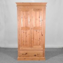 A modern pine double wardrobe, with a drawer below 102 w x 57d x 199h cm