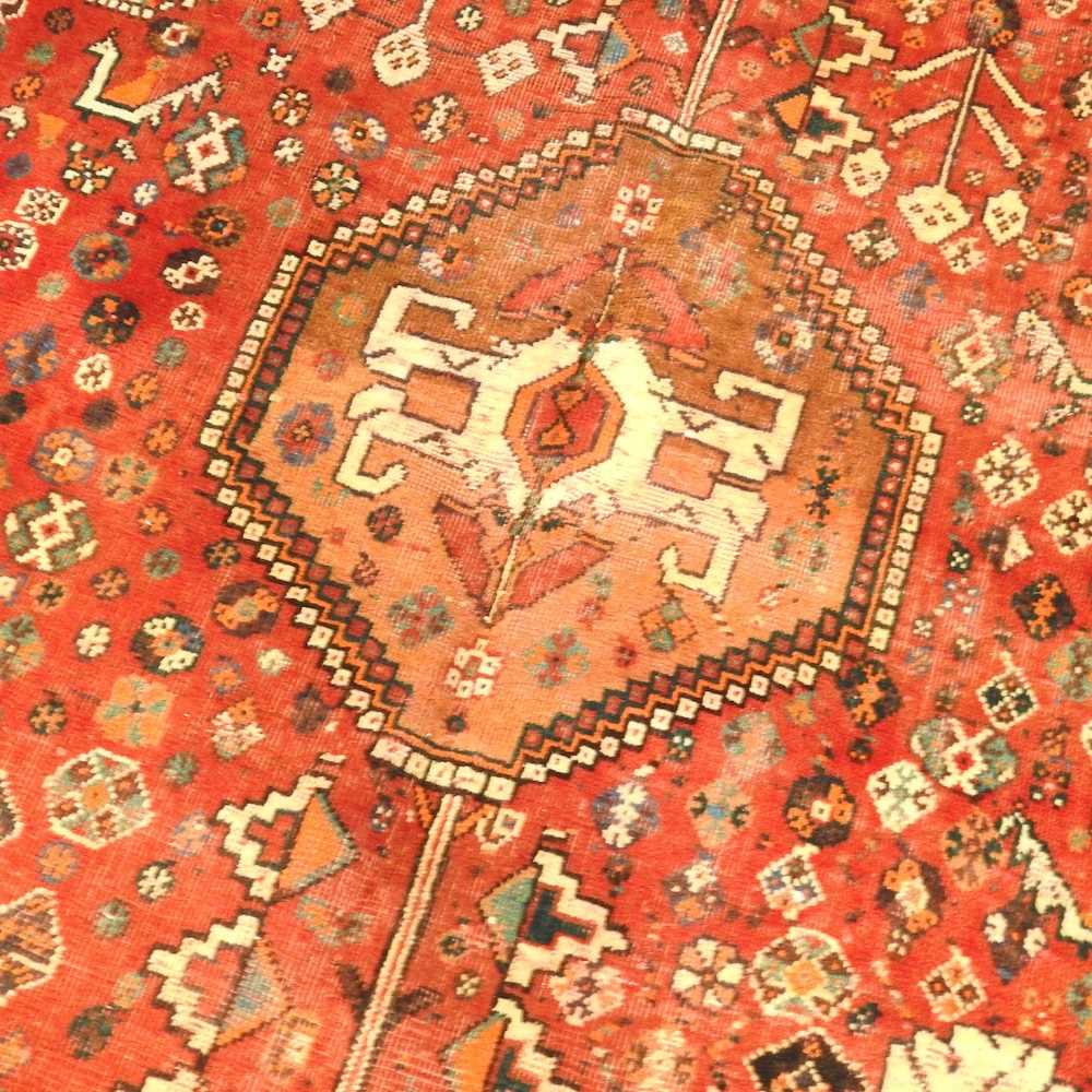A Persian rug, with a central hooked medallion, on a red ground, 200 x 145cm - Image 3 of 5