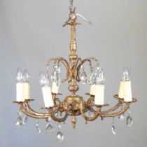 A gilt metal eight branch chandelier, suspended with cut glass drops, 52cm diameter