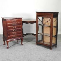 An Edwardian glazed display cabinet, together with an early 20th century music cabinet and an