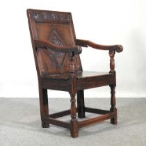 A 17th century and later oak wainscot chair, with a lozenge carved panelled back and plank seat on