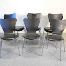 A set of nine black stacking dining chairs, in the style of Fritz Hansen, with black laminated