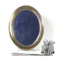 A modern silver model of two cats, shown seated, 7cm high, together with an oval silver photograph