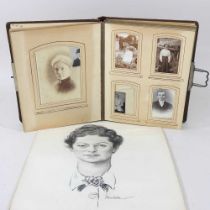 An early 20th century photograph album, together with a pastel portrait, of a lady, unframed (2)