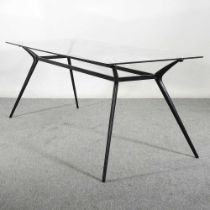 A contemporary dining table, with a glass top, on a splayed metal base 182w x 80d x 76h cm