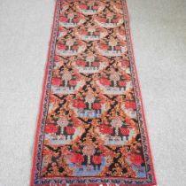 A Persian runner, with all over stylised floral motifs, 275 x 98cm