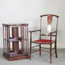 An Edwardian mahogany and inlaid revolving bookcase, together with an Edwardian open arm chair (2)