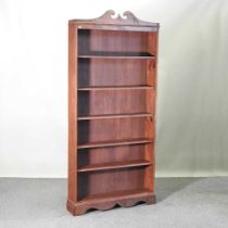 A pine standing open bookcase, with a swan neck pediment 95w x 22d x 210h cm Overall complete and