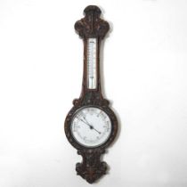 A large Victorian carved oak cased aneroid barometer, decorated with scrolls and flowers, 113cm high
