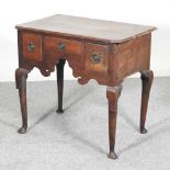 An 18th century oak lowboy, containing three short drawers, above a shaped apron 78w x 48d x 72h cm