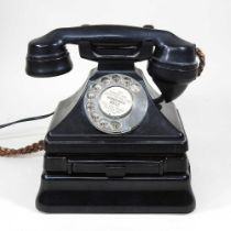 A vintage black bakelite GPO telephone, on stand, 22cm high