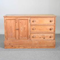 An antique pine side cabinet, on a plinth base 132w x 50d x 85h cm