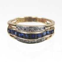 A 14 carat gold sapphire and diamond channel set ring, 3.4g, size N