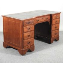 An Edwardian mahogany and satinwood crossbanded inverted breakfront pedestal desk, with an inset