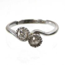 A 9 carat gold and platinum set diamond ring, with two illusion offset diamonds, 2g, size N/O,