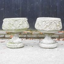 A pair of cast stone garden planters, each on a pedestal base, 49cm high