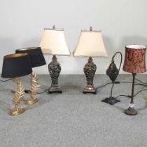 A pair of gilt table lamps, with black shades, 54cm high, together with another pair and two