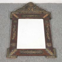 An ornate wall mirror, with embossed metal mounts, 92 x 59cm 92 x 59cm