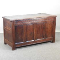 An 18th century panelled oak coffer, with a hinged lid 143w x 61d x 82h cm