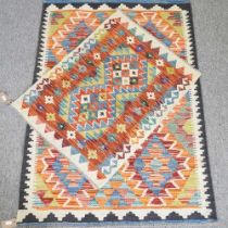 A kilim rug, with all over diamonds, 120 x 85cm, together with another, 78 x 60cm (2)