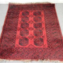A Bokhara rug, with two rows of medallions, on a red ground, 225 x 168cm