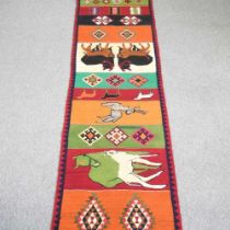 A kelim runner, decorated with coloured panels of animals and geometric designs, 450 x 80cm