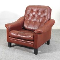 A mid 20th century Danish brown upholstered button back armchair