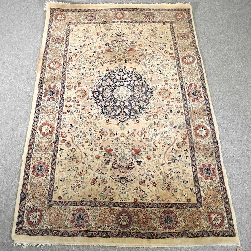 An Indian rug, with a central medallion and floral design, on a cream ground, 221 x 140cm