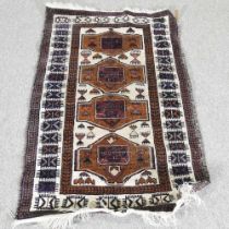 A small Turkish rug, with a row of four central medallions, 132 x 79cm