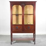 An Edwardian glazed display cabinet, on square legs, united by an undertier 109w x 38d x 175h cm