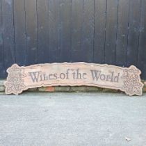 A pokerwork wooden sign, inscribed Wines of the World, 190cm wide