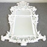 A large and ornate wall mirror, the marginal plate, within a white painted scrolled surround, 181