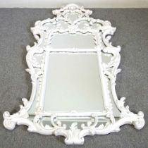 A large and ornate wall mirror, the marginal plate, within a white painted scrolled surround, 181