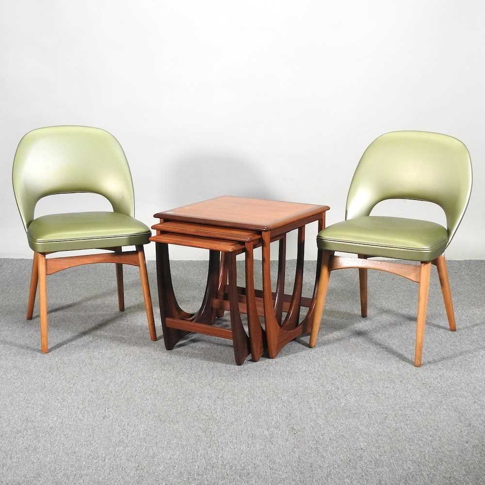 A pair of green upholstered side chairs, together with a nest of three 1970's teak G Plan occasional