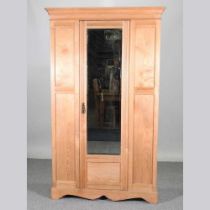 An Edwardian light ash single wardrobe, with a mirrored door 116w x 44d x 195h cm