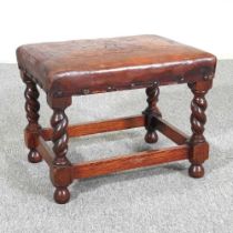 A 1920's leather upholstered footstool