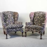 A pair of early 20th century floral upholstered wing back armchairs, on claw and ball feet (2)