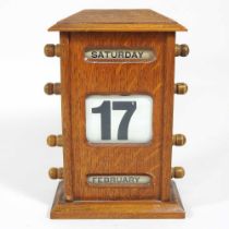 An early 20th century light oak desk calendar, 21cm high Overall condition is usable and complete.