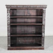 A 19th century carved oak dwarf open bookcase, with Green Man decoration 101w x 31d x 117h cm