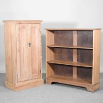 An early 20th century pitch pine two door cabinet, fitted with shelves, together with a dwarf open