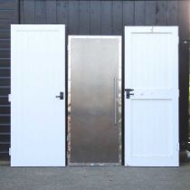 A chrome effect interior door, 183 x 76cm, together with two painted wooden interior doors (3)