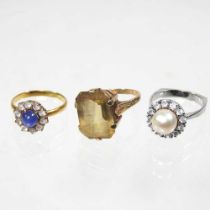 A 9 carat gold citrine dress ring, 5.8g, size O, boxed, together with two cluster rings (3)