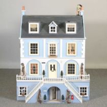 A light blue painted doll's house 84w x 54d x 80h cm