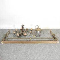 A 19th century brass fender, together with an eight branch chandelier and a brass lantern 149w x 42d
