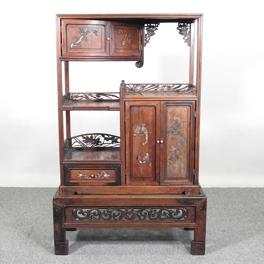 An early 20th century Japanese shibayama inlaid hardwood cabinet on stand, with fret carved
