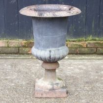 A black painted cast iron campana shaped garden urn, 70cm high