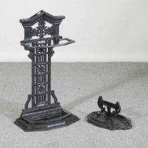 A black painted cast iron stick stand, 76cm high, together with a cast iron bootscraper (2)