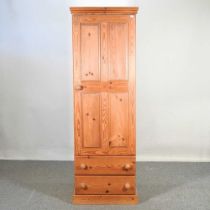 A modern pine cupboard, with drawers below 60w x 34d x 181h cm