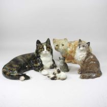 A Winstanley pottery cat, reclining, painted marks, 36cm, together with another, a Beswick cat and